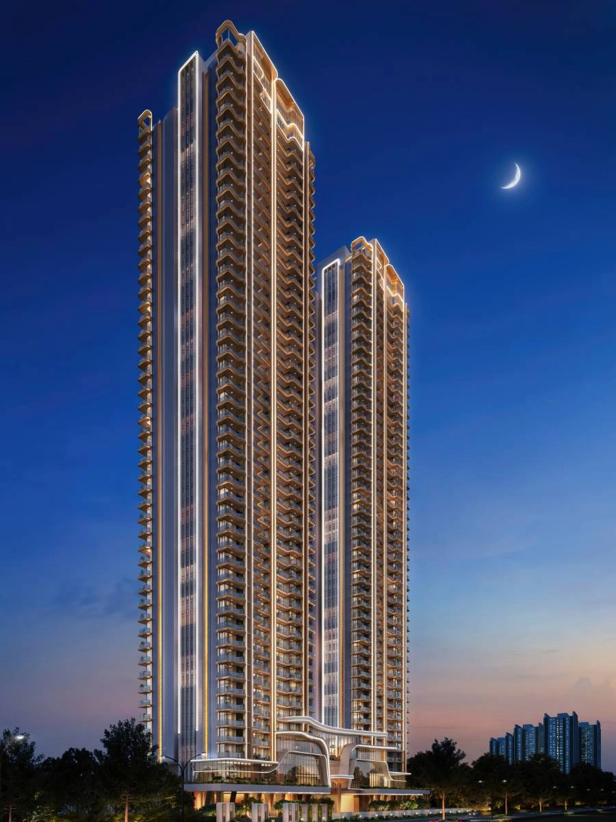 The Oryza twin towers and clubhouse podium illuminated at night, Gurugram